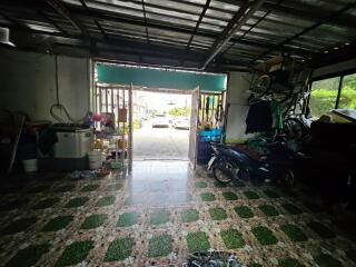 View of a garage with vehicles and storage items