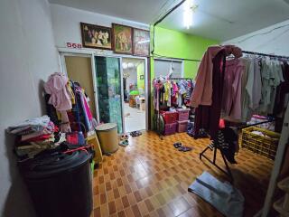 Bedroom with clothes hanging and storage area