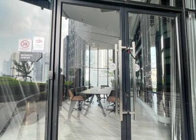 Glass doors leading into a modern building with a business center