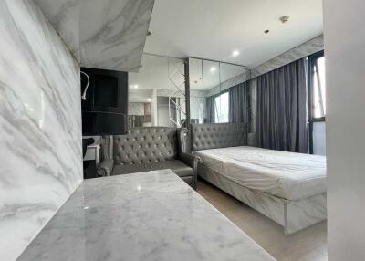 Modern bedroom with marble walls and a large bed