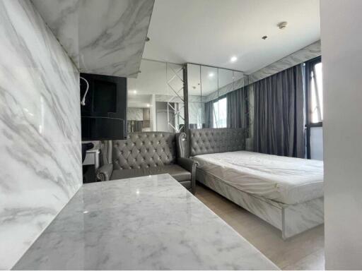 Modern bedroom with marble walls and a large bed