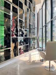 Modern living area with floor-to-ceiling windows and decorative shelving