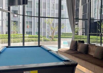 Modern recreational area with a pool table and a view of the pool
