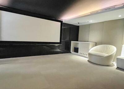 Home theater room with large screen and comfortable seating