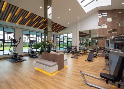 Spacious and modern fitness center with equipment and large windows