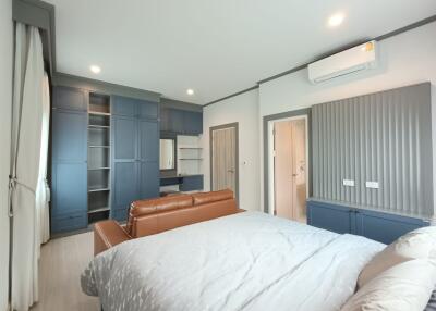 Spacious bedroom with modern furnishing and storage solutions