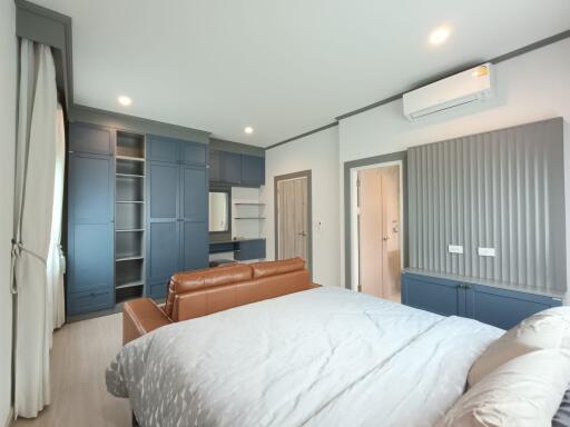 Spacious bedroom with modern furnishing and storage solutions