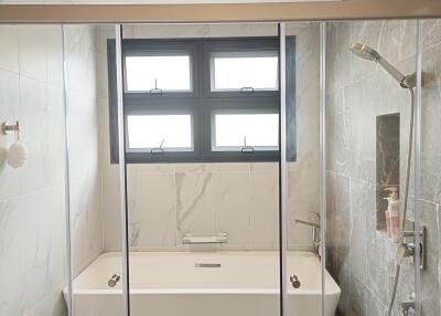 Modern bathroom with a bathtub and shower area