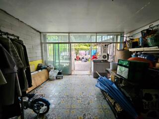 Utility room with various storage items and access to outdoor area