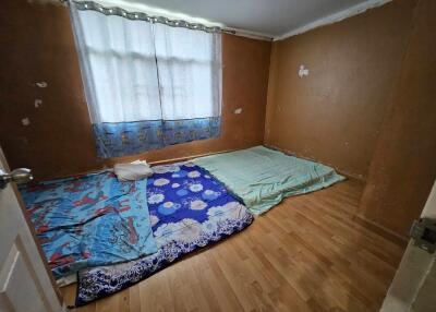 Bedroom with mattresses on the floor and natural light