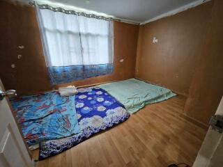 Bedroom with mattresses on the floor and natural light