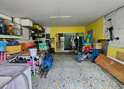 A garage with various stored items, including tools, boxes, a bicycle, and a closet.