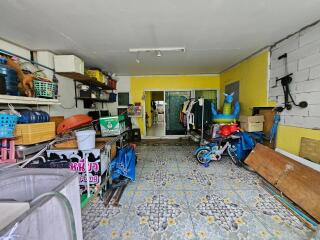 A garage with various stored items, including tools, boxes, a bicycle, and a closet.