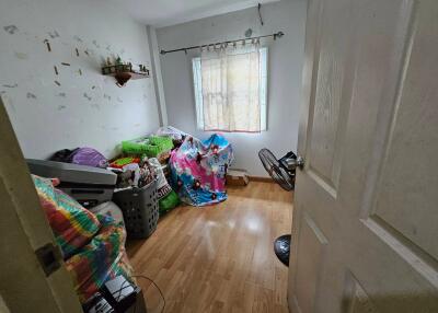 Bedroom with clutter and hardwood floor