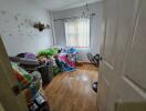 Bedroom with clutter and hardwood floor