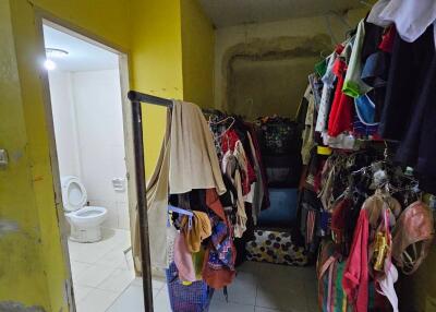 Multifunctional area with clothing rack and view of bathroom