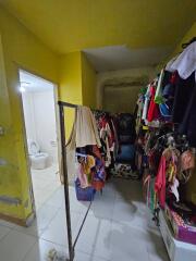 Multifunctional area with clothing rack and view of bathroom