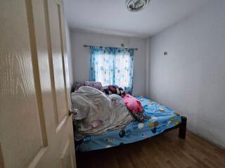 messy bedroom with bed and window