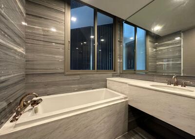 Modern bathroom with bathtub and large mirror