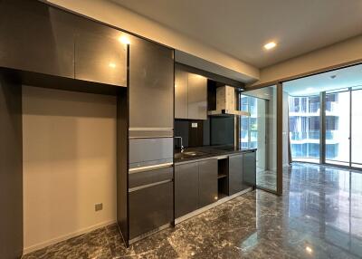 Modern kitchen with dark cabinets and marble flooring