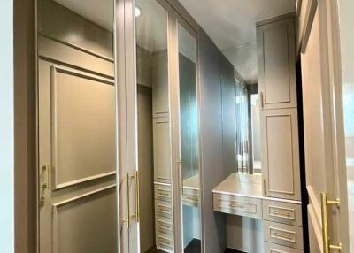 Spacious walk-in closet with mirrored doors and ample storage