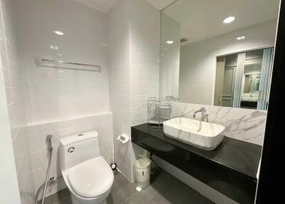 Modern bathroom with sleek fixtures and large mirror