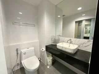 Modern bathroom with sleek fixtures and large mirror