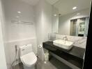 Modern bathroom with sleek fixtures and large mirror