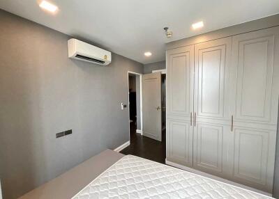 Modern bedroom with built-in wardrobe and air conditioner