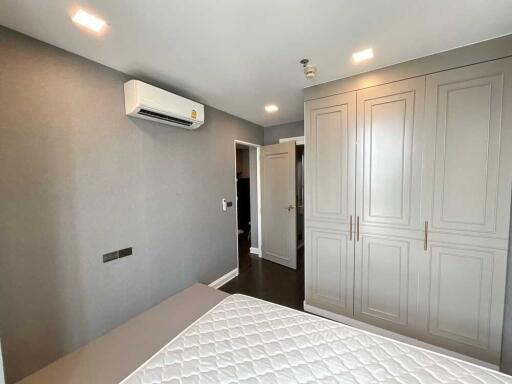 Modern bedroom with built-in wardrobe and air conditioner