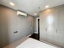 Bedroom with large wardrobe and air conditioning