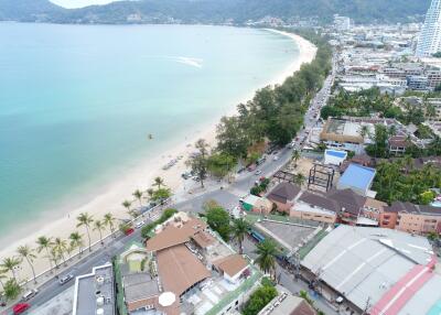 Aerial view of beachfront property with surrounding amenities