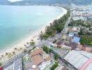 Aerial view of beachfront property with surrounding amenities