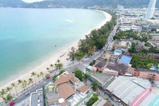 Aerial view of beachfront property with surrounding amenities