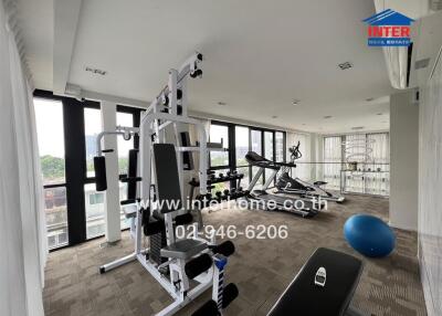 In-house fitness center with modern gym equipment and city views