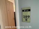 Entrance to condominium unit with door and unit number