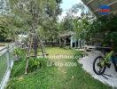 Image of a garden with a variety of greenery, a bicycle, and a sitting area