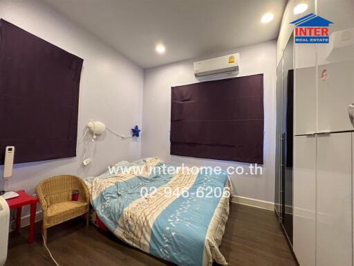 Cozy bedroom with double bed, modern furniture, and air conditioning