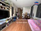 Bedroom with wooden flooring, TV stand, bed, and various personal items