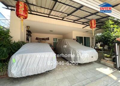 Covered garage with two parked cars