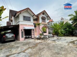 Two-story house with a driveway and carport