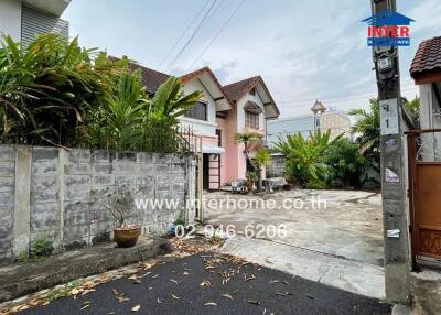 Front view of a house with driveway and garden