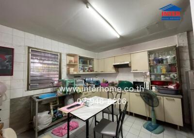 Kitchen with dining table and various kitchen appliances