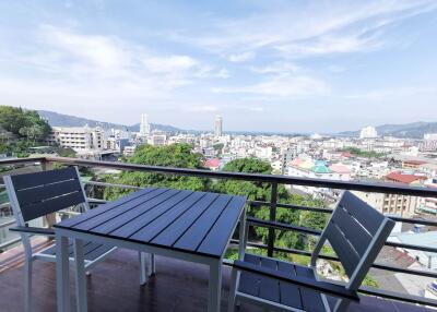 View from balcony overlooking city and ocean