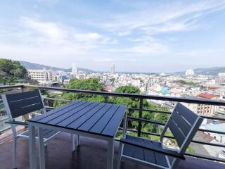 View from balcony overlooking city and ocean