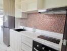 Modern kitchen with built-in appliances and tiled backsplash