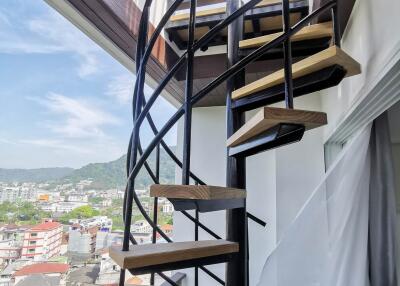Spiral staircase with a city view