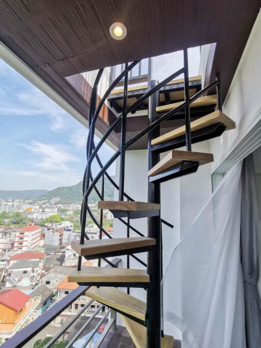 Spiral staircase with a city view