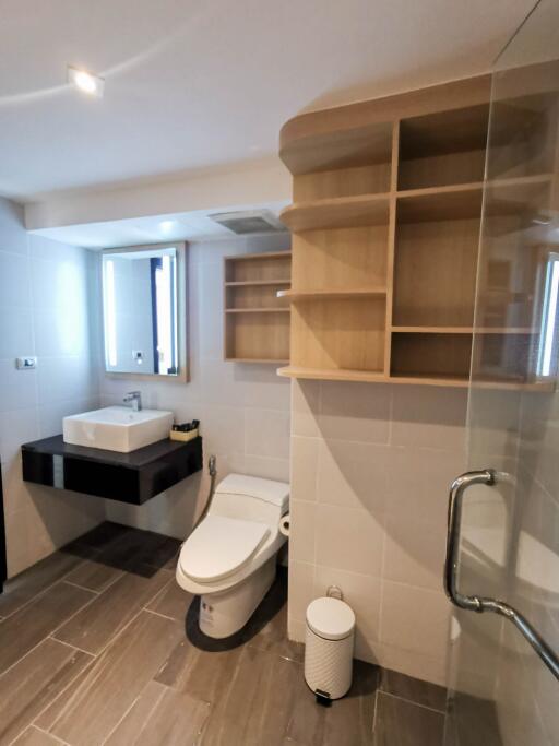 Modern bathroom with sink, toilet, and shower area