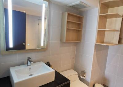 Modern bathroom with sink, mirror, and toilet